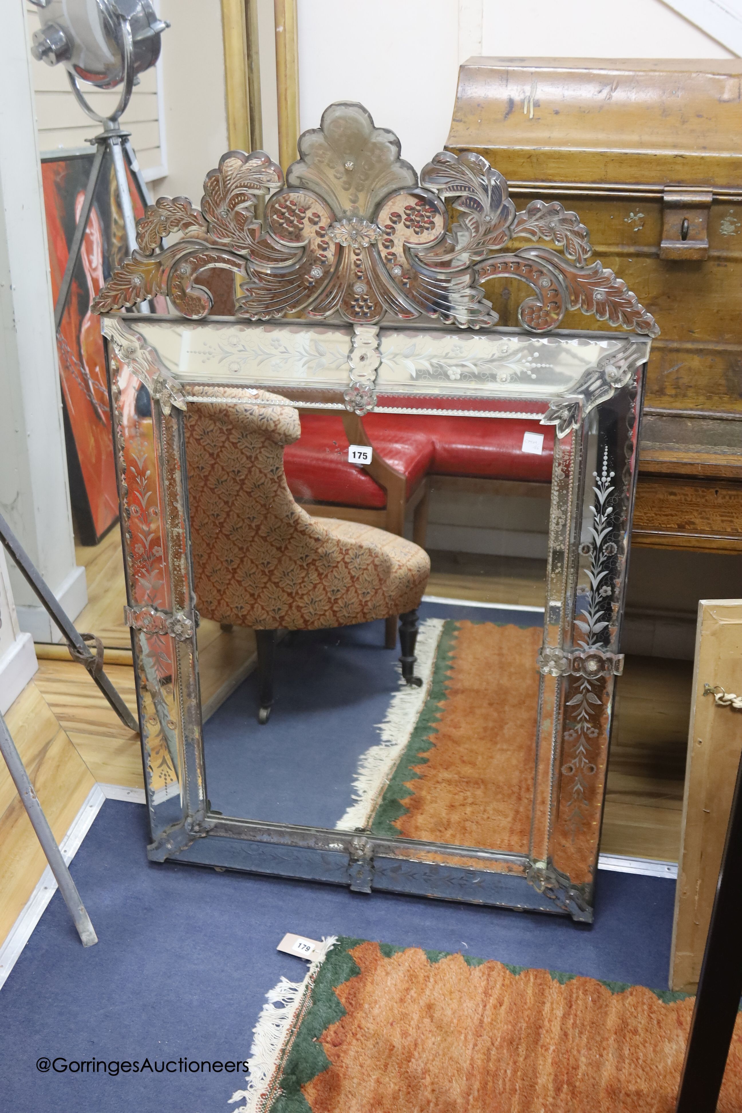 A large 19th century Venetian glass overmantel, elaborate leaf cresting and engraved detail